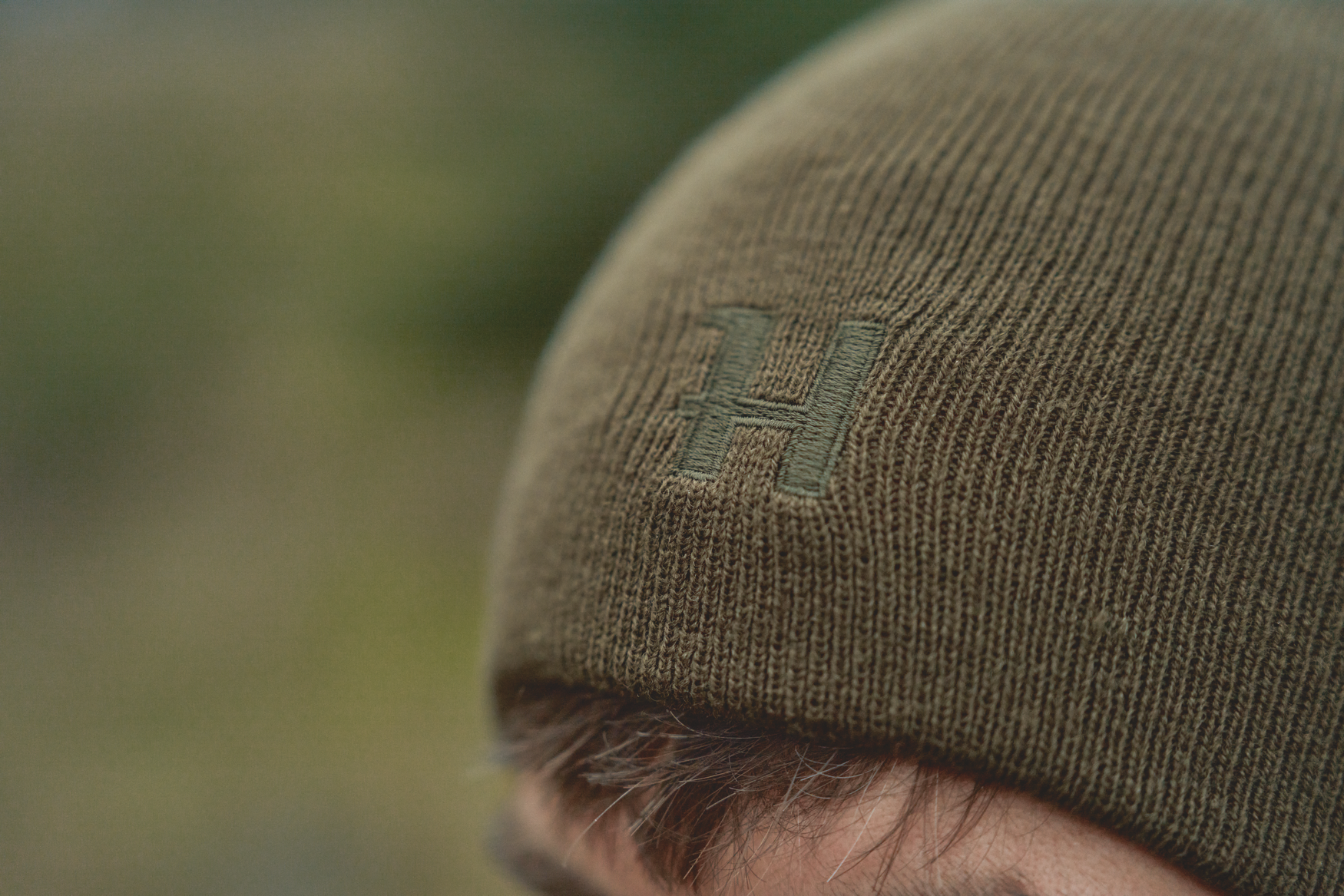 Härkila reversible beanie - Willow green/Orange